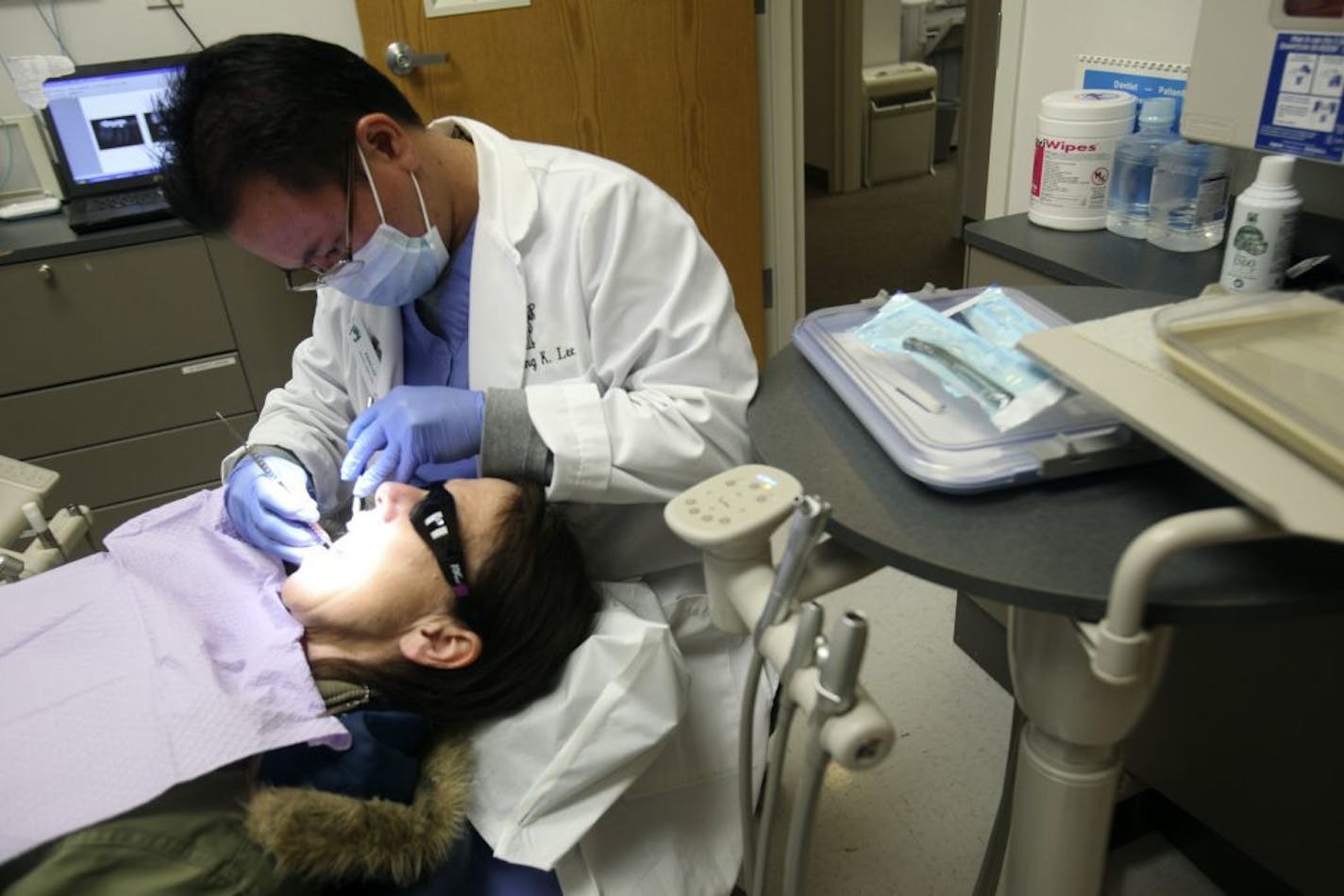 Dr. Xieng Lee checked Marcia Hokenson's teeth at Southside Community Health Center in Minneapolis in 2011. The community clinic gets 30 percent of its budget from the $2.55 million the federal funding provides.