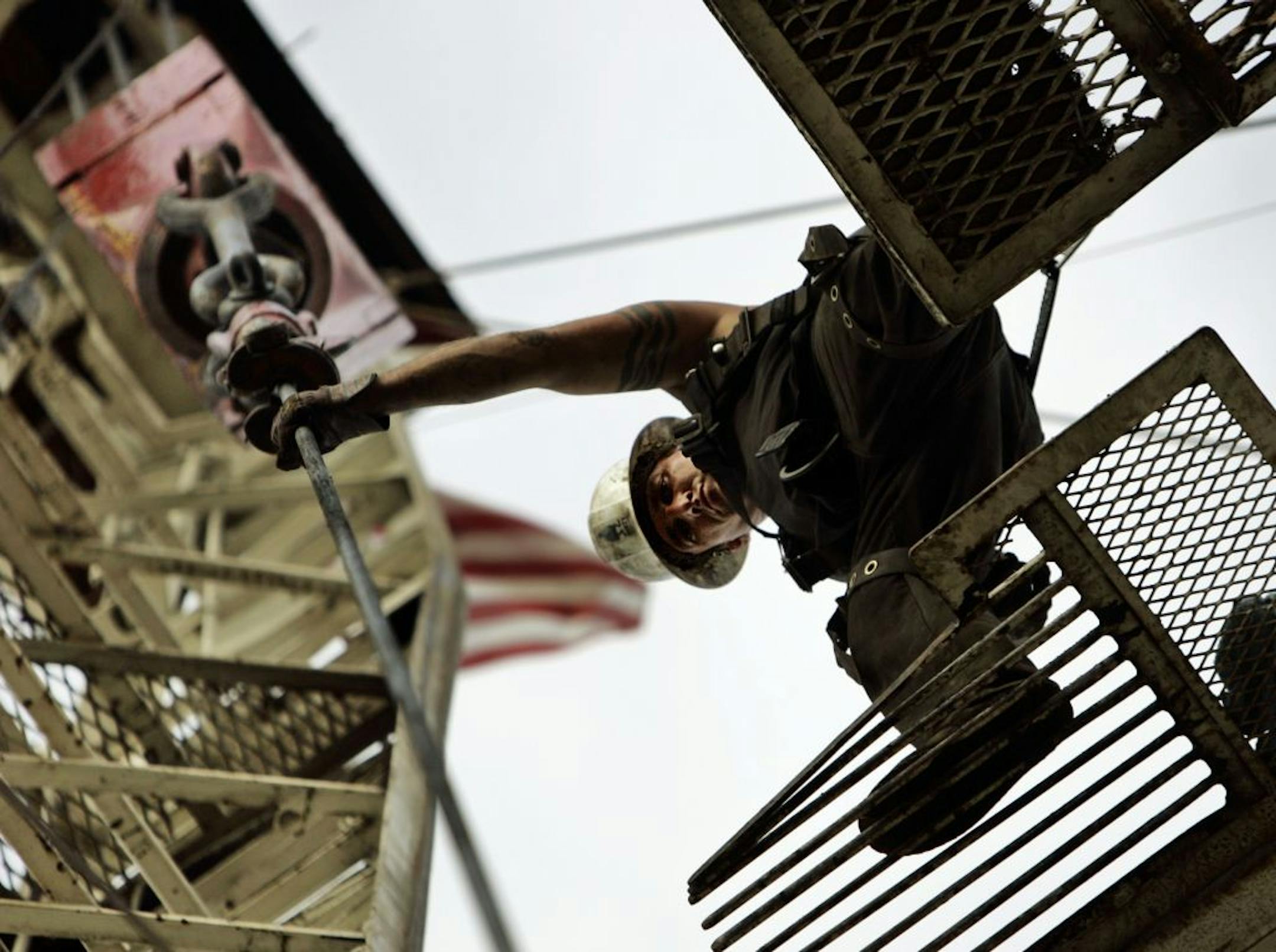 In this file photo, a man guides a length of pipe being removed from an oil well in Signal Hill, Calif., Friday, March 14, 2008.