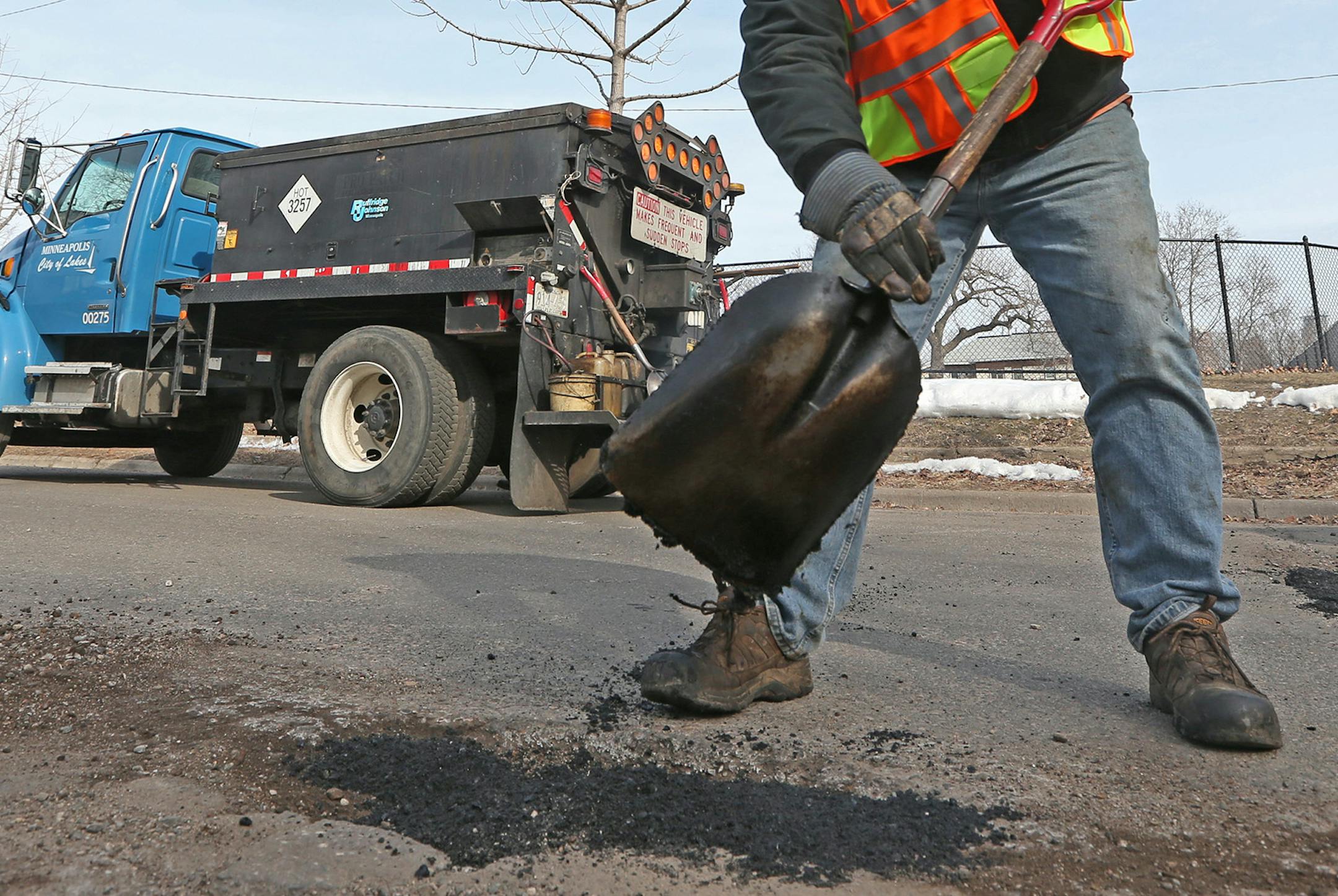 (left to right) Minneapolis city worker Mike Flaferty patched potholes near Clinton Ave South and 25th Street in Minneapolis on 3/26/14.] Bruce Bisping/Star Tribune bbisping@startribune.com Ben White, Mike Flaferty/source. ORG XMIT: MIN1403261551551139