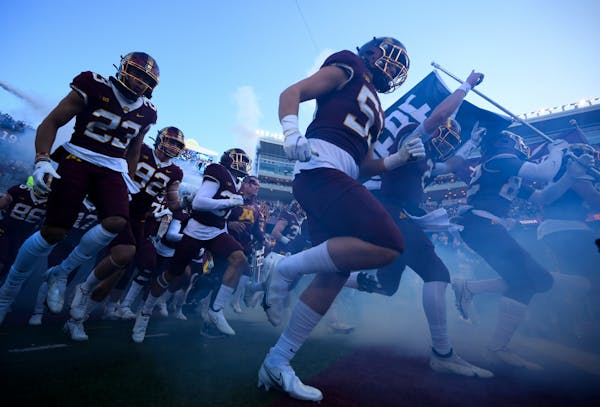 The Minnesota Gophers take the field before the start of an NCAA football game between the Gophers and the Wisconsin Badgers Saturday, Nov. 27, 2021 a