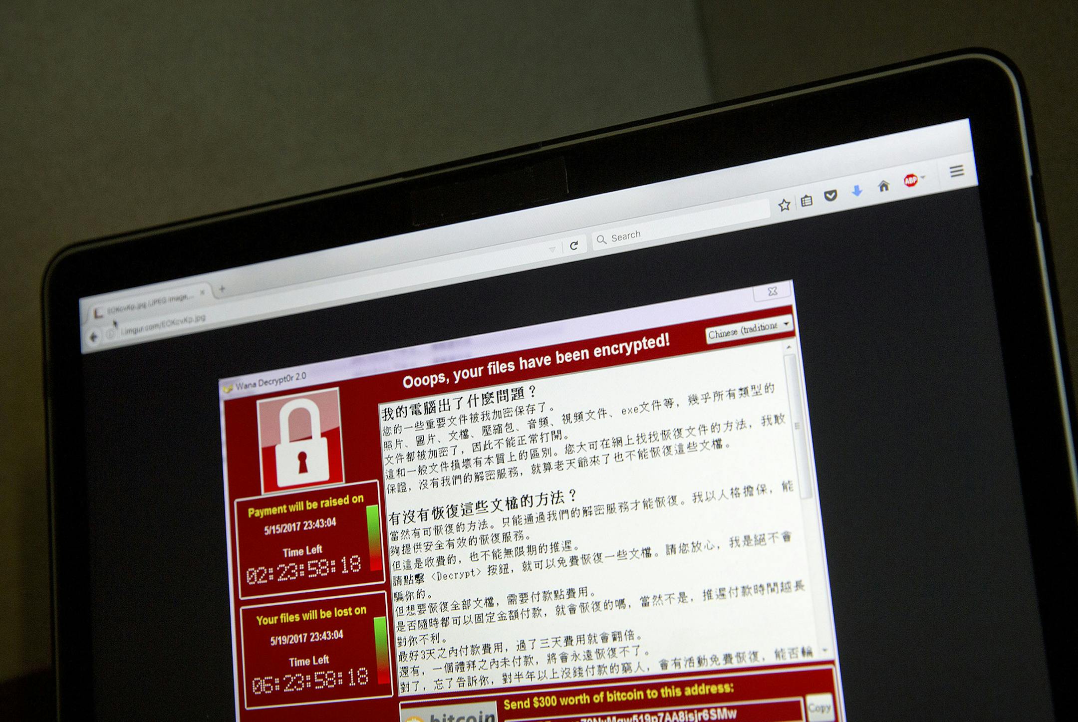 FILE - In this May 13, 2017 file photo, a screenshot of the warning screen from a purported ransomware attack, as captured by a computer user in Taiwan, is seen on laptop in Beijing. Global cyber chaos is spreading Monday, May 14, as companies boot up computers at work following the weekend's worldwide "ransomware" cyberattack. The extortion scheme has created chaos in 150 countries and could wreak even greater havoc as more malicious variations appear. The initial attack, known as "WannaCry," p