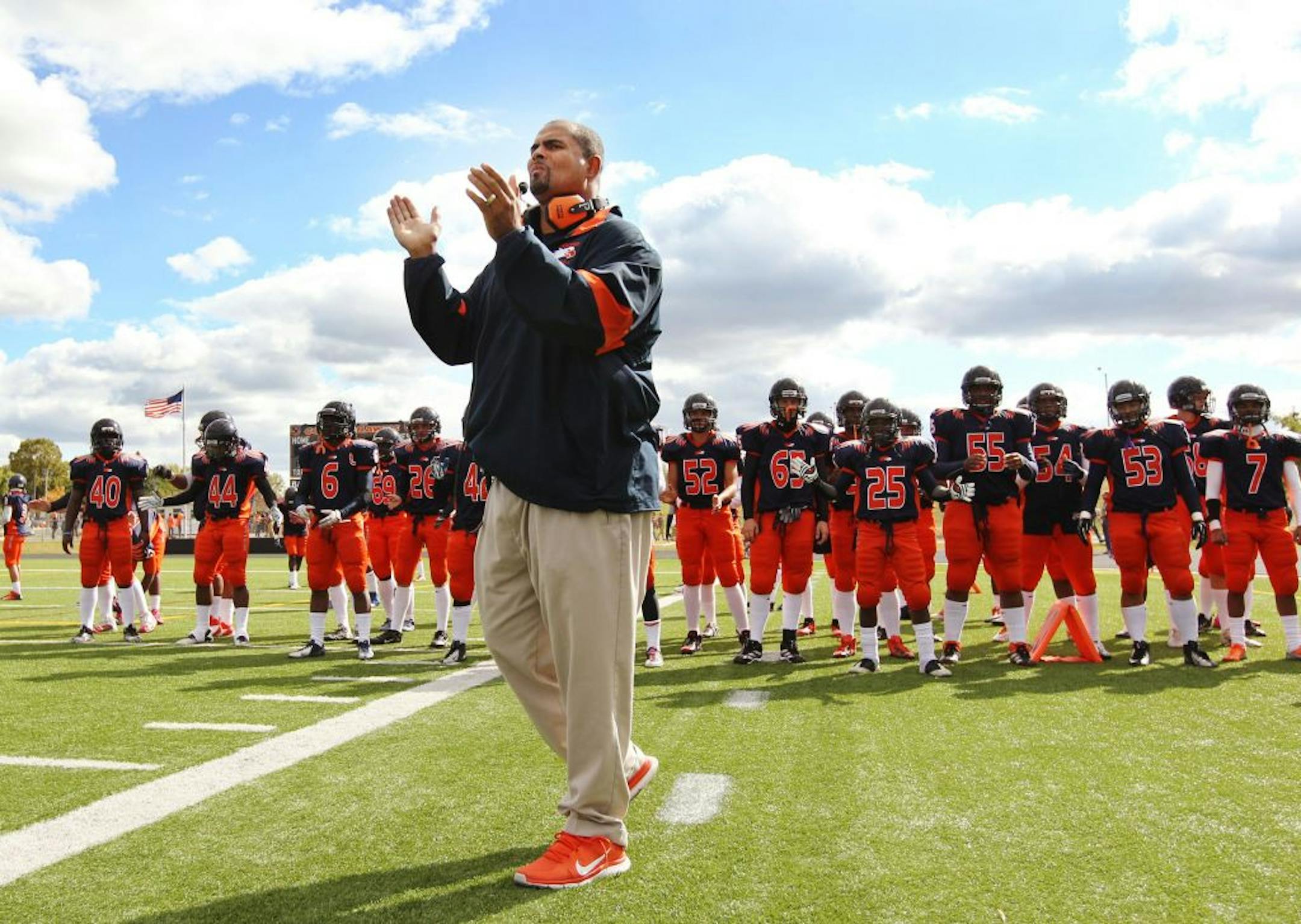 Cooper High School football coach Willie Howard cheers on the marching band with his team before their game against Spring Lake Park on Sept. 22 in New Hope. Photo: Genevieve Ross/Special to the Star Tribune