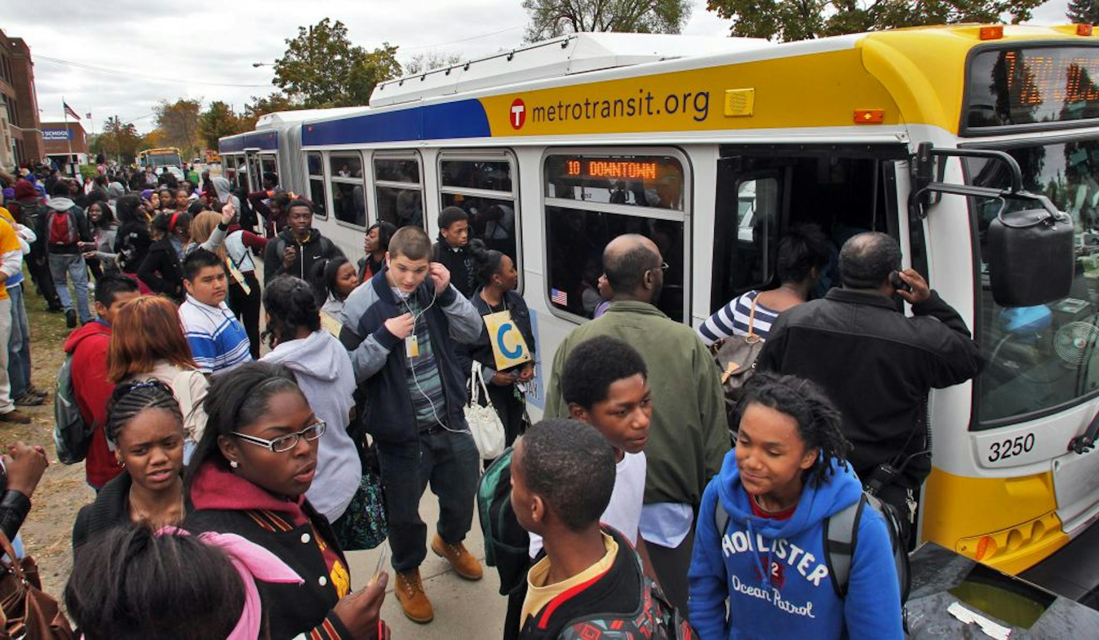 Students from Edison High School in Minneapolis board Metro Transit buses in front of the school at the end of the school day.