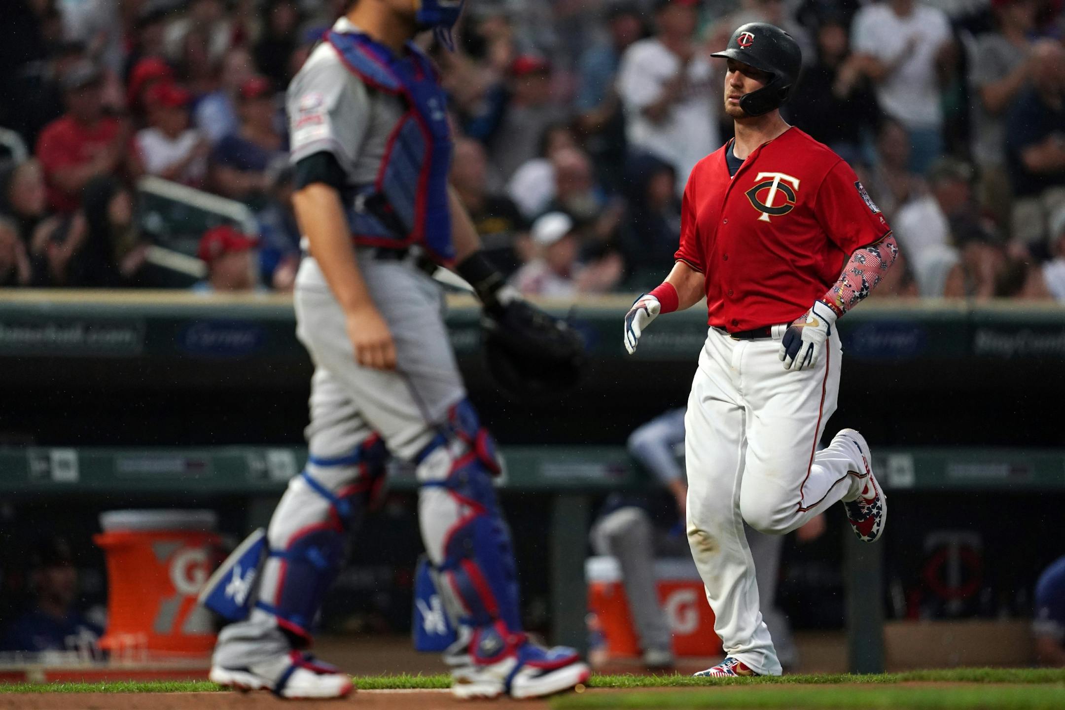 Minnesota Twins catcher Mitch Garver (18) scored on a single hit by Minnesota Twins left fielder Marwin Gonzalez (9) in the second inning.