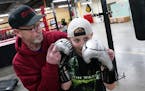 Mike Evgen explained technique to Soren Holdahl, 10, as they worked out with a punching bag. ] ANTHONY SOUFFLE &#x2022; anthony.souffle@startribune.co