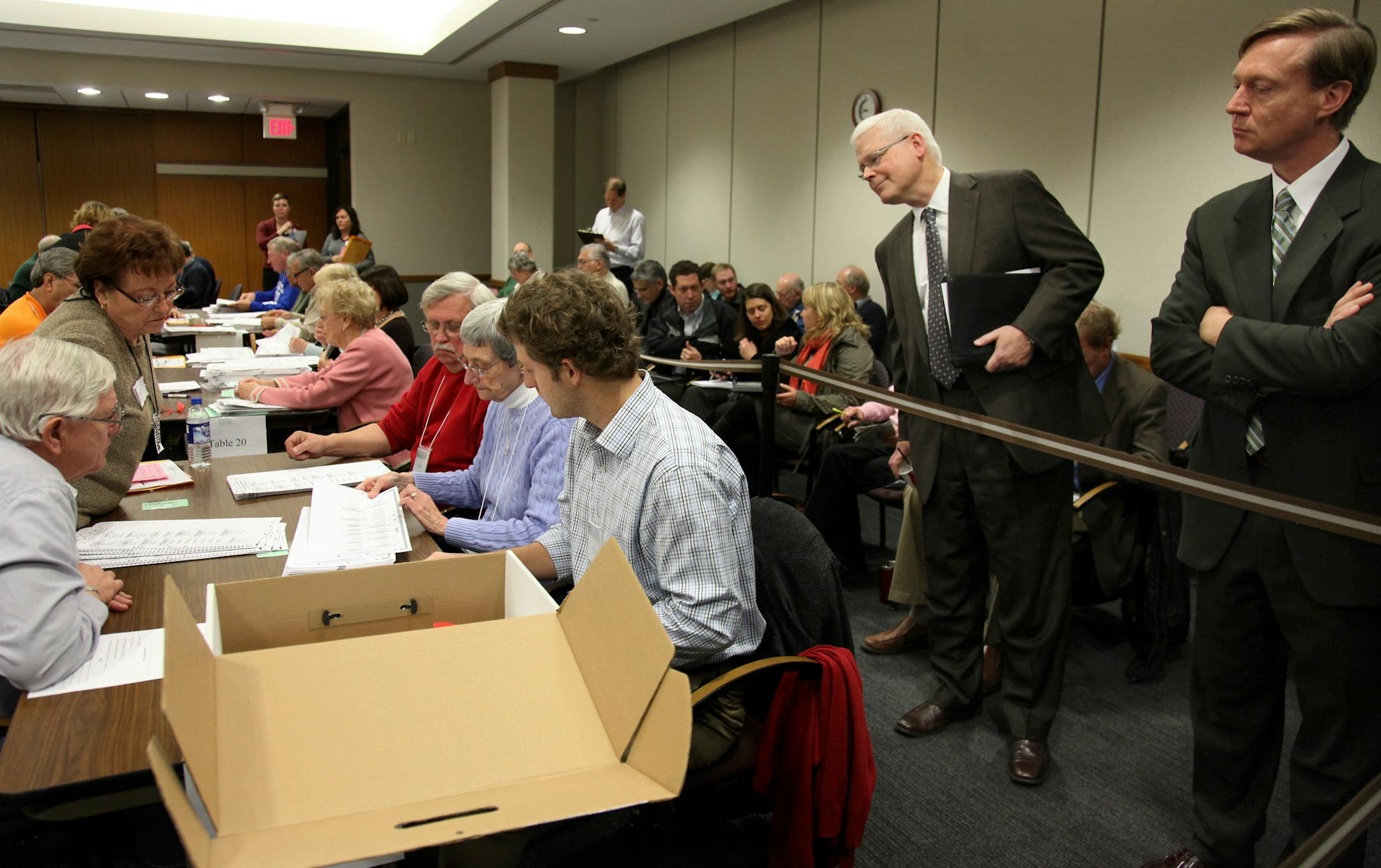 David Lillehaug, Mark Dayton's attorney, left, and a representative for Emmer watched as ballots were counted and challenged at the Hennepin County Government Center in November 2010.