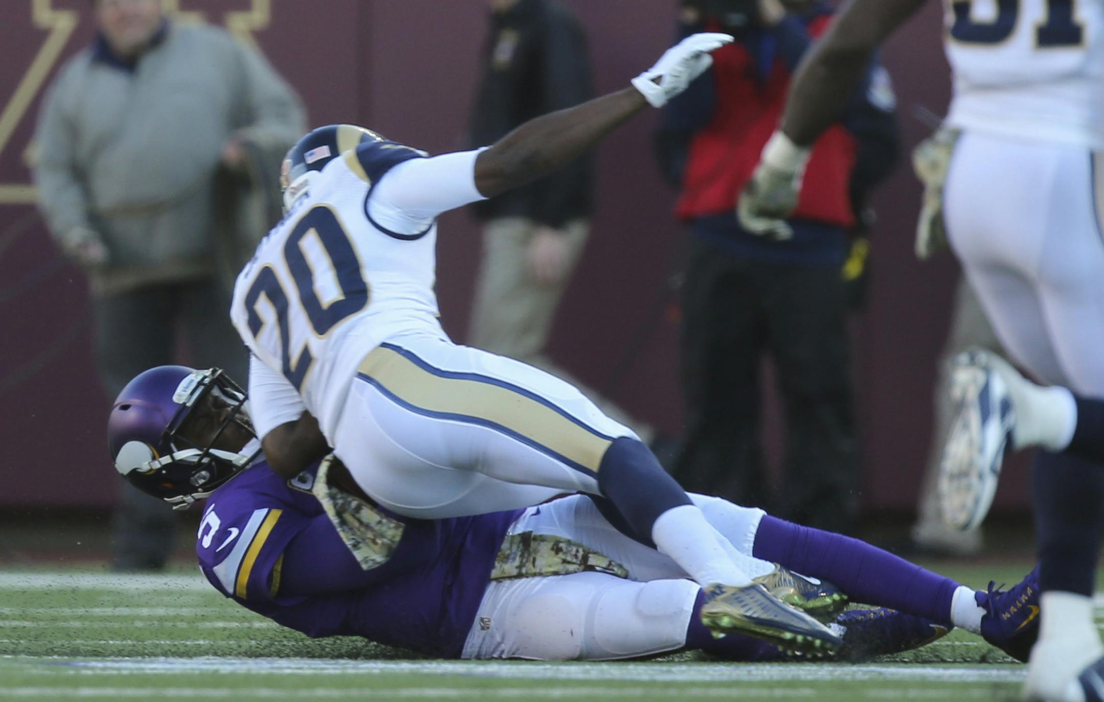Vikings quarterback Teddy Bridgewater scrambled for a five yard gain before being hit hard by Rams cornerback Lamarcus Joyner (20) as he slid to the ground in the fourth quarter Sunday afternoon. Joyner was penalized for unnecessary roughness on th play. Bridgewater left the game after the hit. ] JEFF WHEELER &#xef; jeff.wheeler@startribune.com The Minnesota Vikings beat the St. Louis Rams 21-18 in overtime on a 40 yard Blair Walsh field goal Sunday afternoon, November 8, 2015 at TCF Bank Stadiu