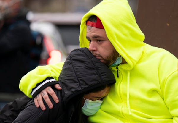 Daunte Wright’s brother, Damik, hugged a friend, before a vigil on Monday, April 12, in Brooklyn Center. 