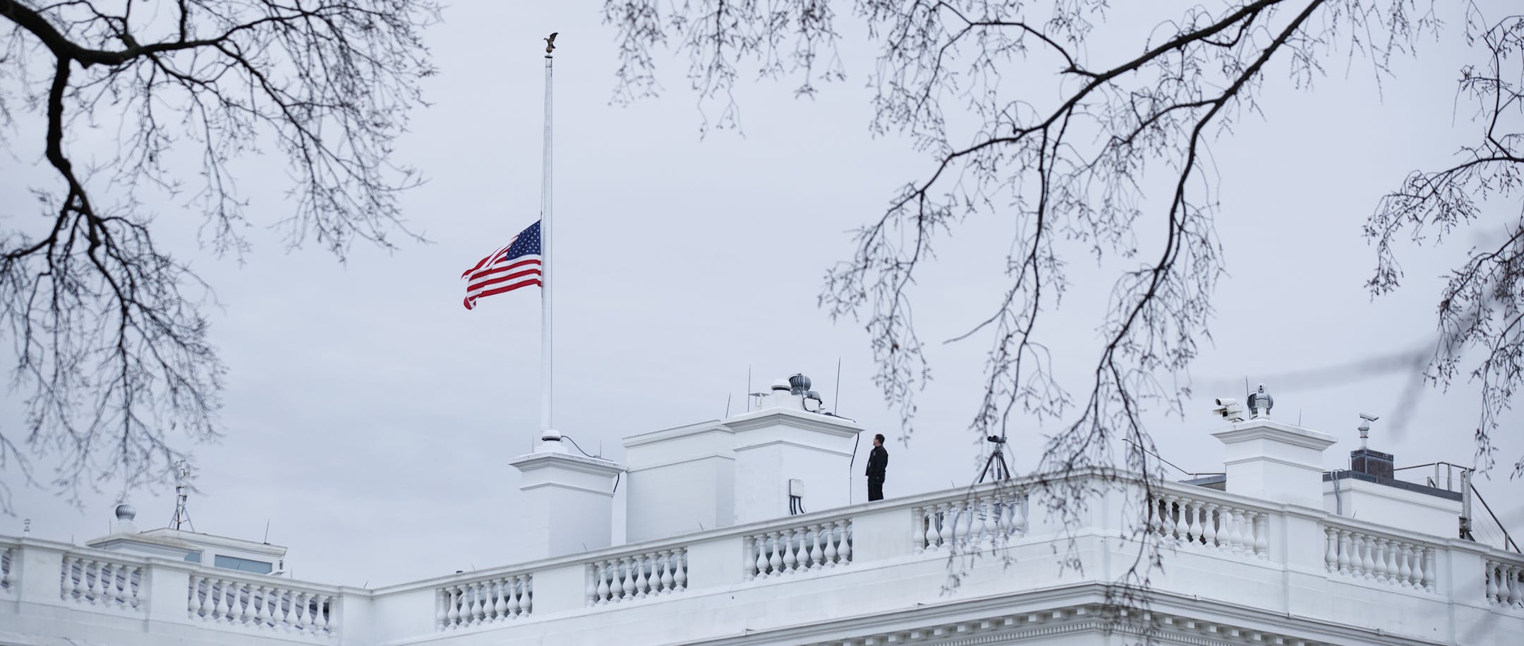 The flag above the White House is lowered to half-staff for the shooting victims of a mass shooting in a South Florida High School, Thursday, Feb. 15, 2018, in Washington. (AP Photo/Evan Vucci)