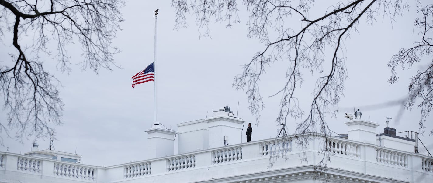 The flag above the White House is lowered to half-staff for the shooting victims of a mass shooting in a South Florida High School, Thursday, Feb. 15, 2018, in Washington. (AP Photo/Evan Vucci)