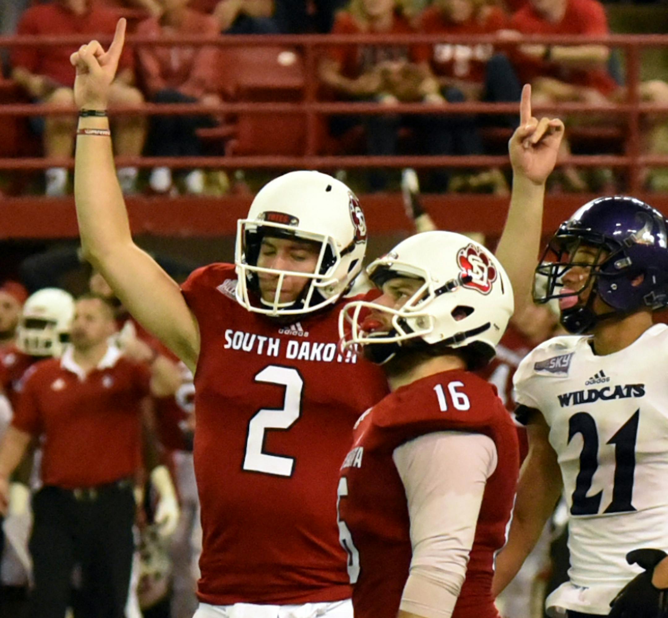 South Dakota players raise their arms in victory after the they beat Weber State 52-49 in an NCAA college football game, Saturday, Sept. 10, 2016 in Vermillion, S.D. (James D. Cimburek/Yankton Press & Dakotan via AP)