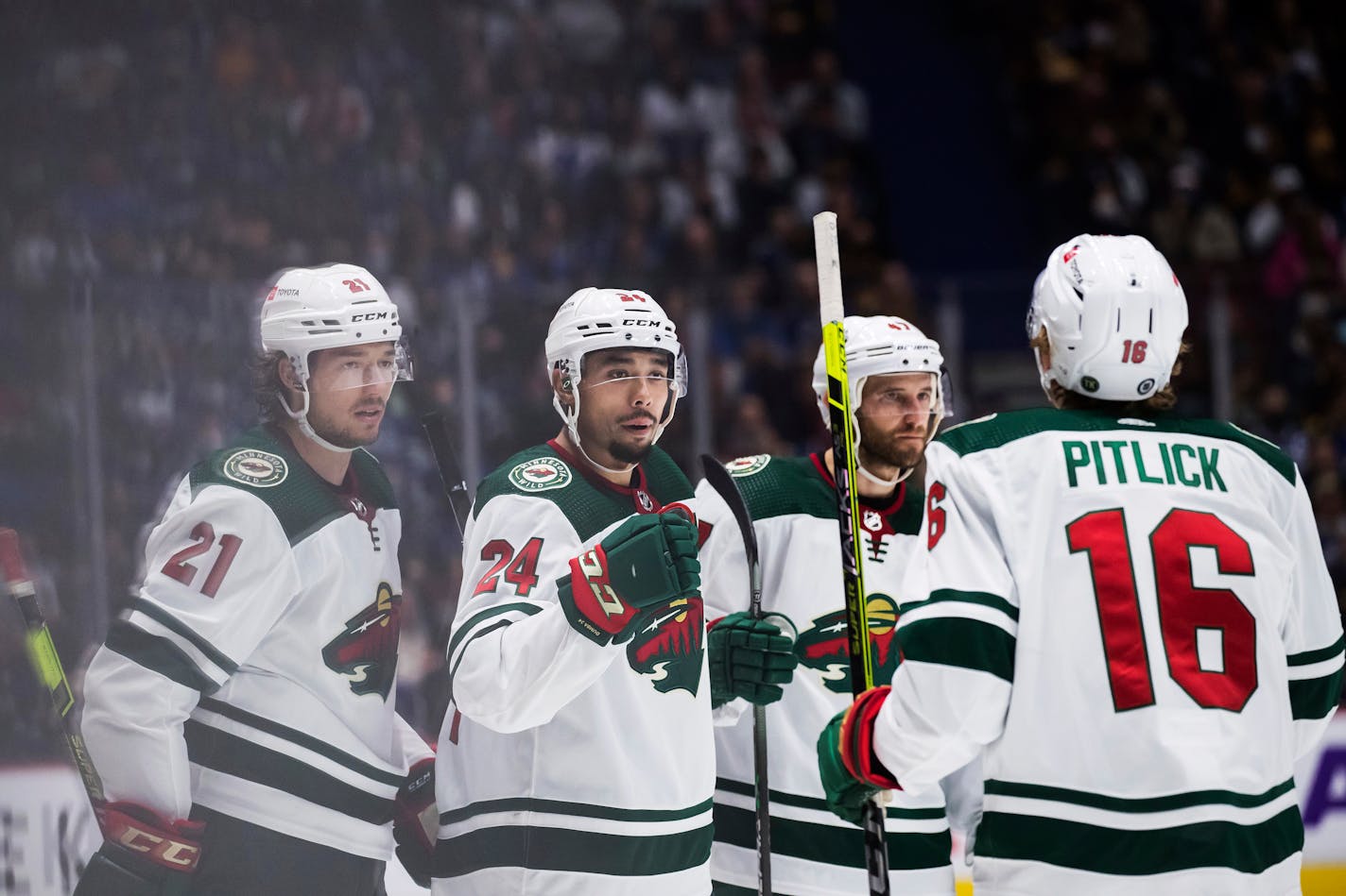 Minnesota Wild's Brandon Duhaime, from left to right, Matt Dumba, Alex Goligoski and Rem Pitlick celebrate Dumba's goal against the Vancouver Canucks during the third period of an NHL hockey game, Tuesday, Oct. 26, 2021 in Vancouver, British Columbia. (Darryl Dyck/The Canadian Press via AP)