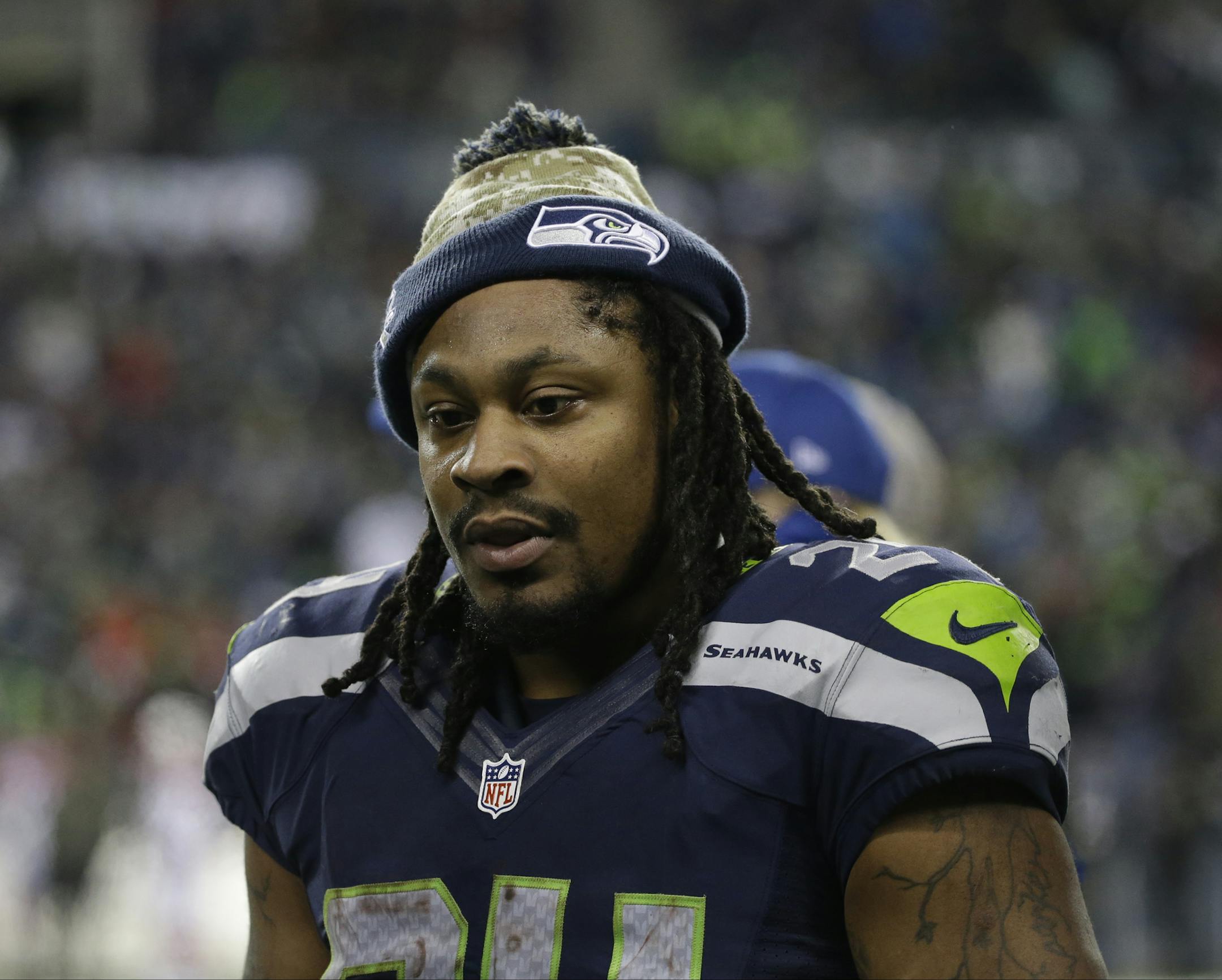 Seattle Seahawks running back Marshawn Lynch talks to teammates on the sideline in the second half of an NFL football game against the Arizona Cardinals, Sunday, Nov. 15, 2015, in Seattle. (AP Photo/Elaine Thompson) ORG XMIT: OTK