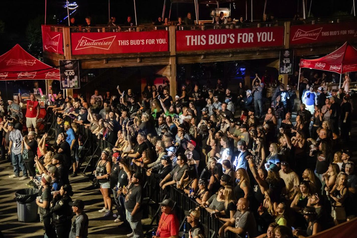 FILE - In this Friday, Aug. 14, 2020, file photo fans attend a performance by Saul at the Iron Horse Saloon during the 80th annual Sturgis Motorcycle Rally, in Sturgis, S.D. South Dakota health officials warned Thursday, Aug. 20, that a number of people who attended the 10-day Sturgis Motorcycle Rally this month, including some who came from out of state, have come down with COVID-19.