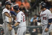 Minnesota Twins Jonathan Schoop, left, is congratulated by Eddie Rosario, center, and Nelson Cruz after hitting a three-run home run against the Balti