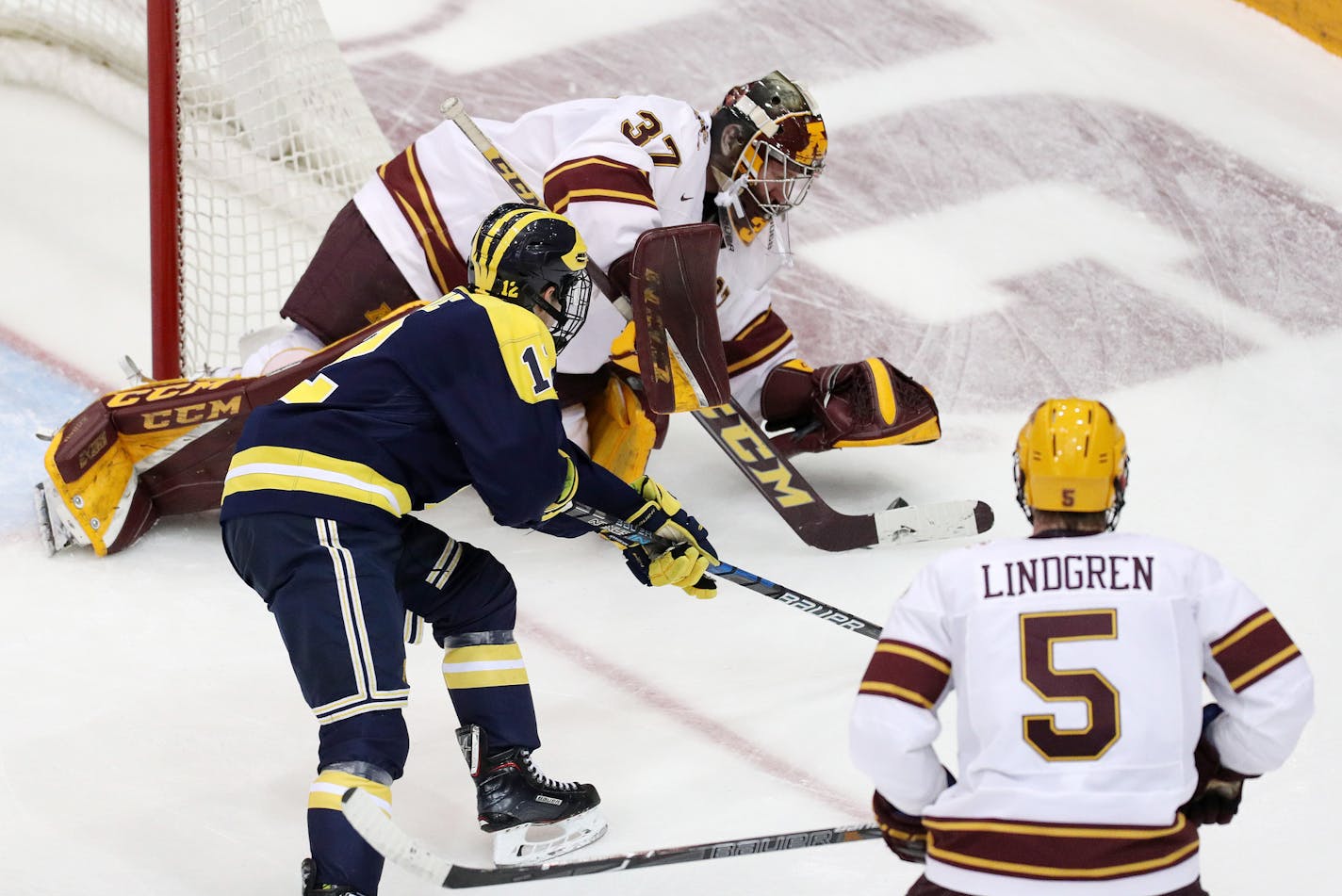 Minnesota Golden Gophers goaltender Eric Schierhorn (37) smothered the puck as Michigan Wolverines forward Dakota Raabe (12) tried to get a shot off in the third period. ] ANTHONY SOUFFLE &#xef; anthony.souffle@startribune.com The Minnesota Golden Gophers men's hockey team played the Michigan Wolverines in an NCAA hockey game Friday, Jan. 12, 2018 at the 3M Arena at Mariucci in Minneapolis