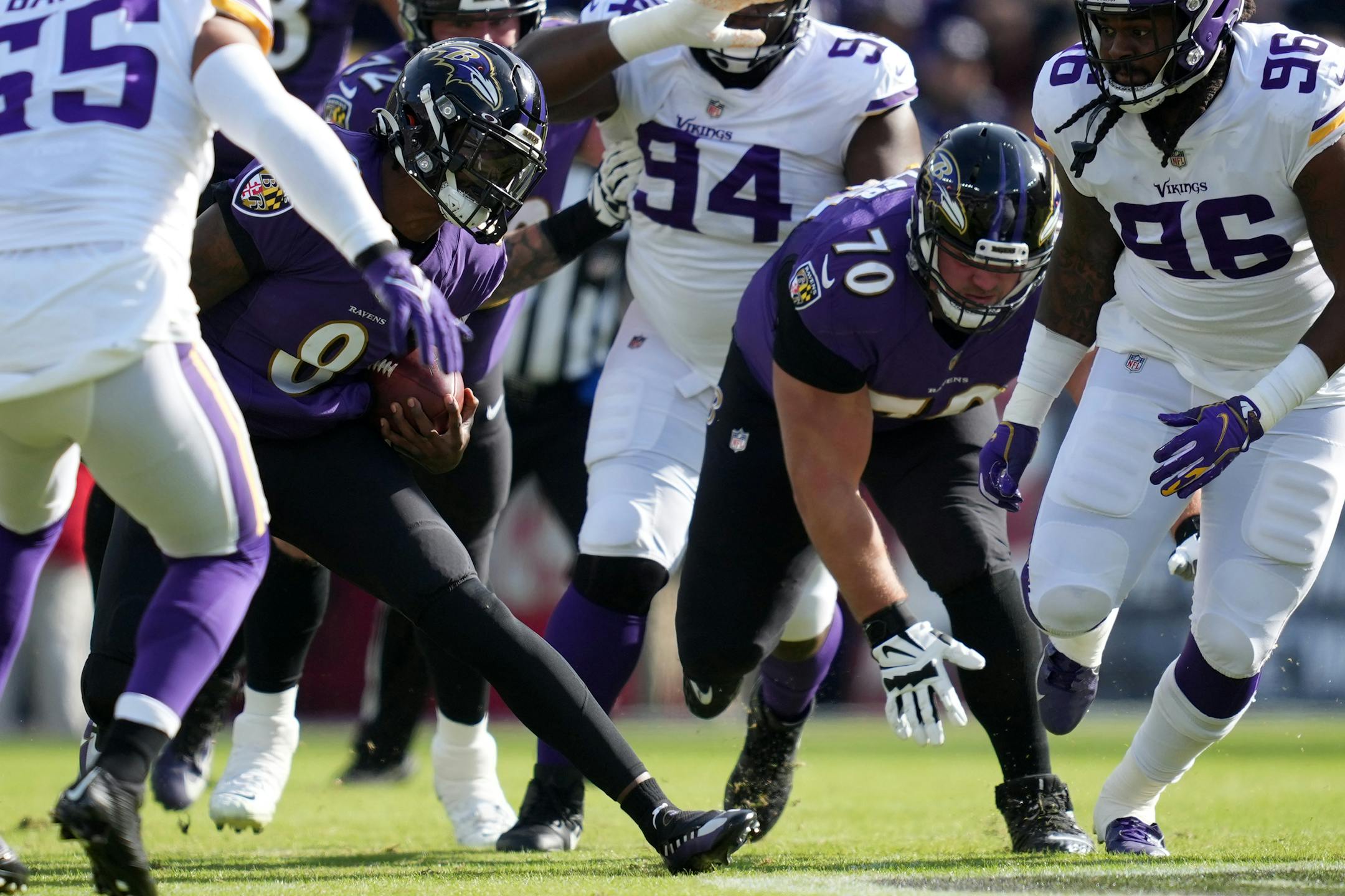 Ravens quarterback Lamar Jackson (8) sprinted around the Vikings defense as he ran the ball in the first quarter of an NFL game between the Minnesota Vikings and the Baltimore Ravens Sunday, Nov. 7, 2021 at M&T Bank Stadium in Baltimore.