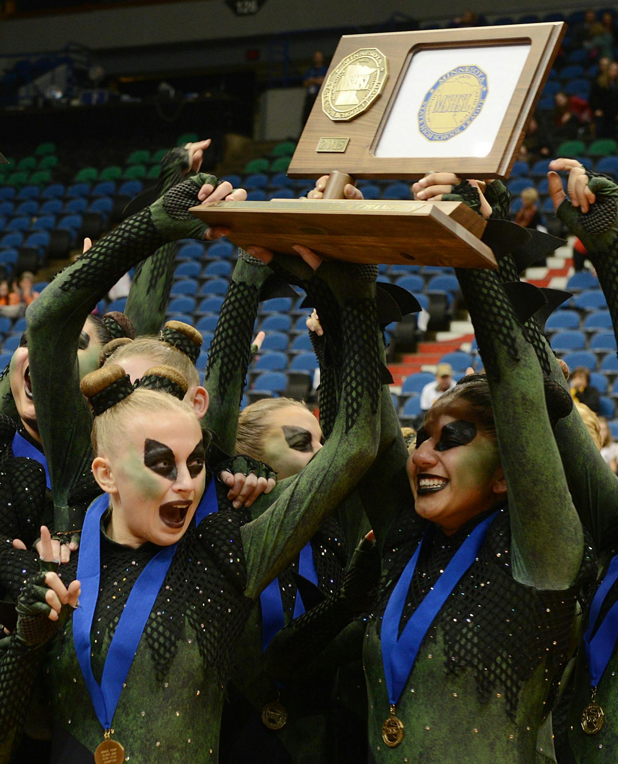 Faribault Emeralds dance team celebrates their announcement of first place in the 3AAA state dance team high kick division tournament by cheering and holding up their trophy on Saturday at Target Center.] BRIDGET BENNETT • Special to the Star Tribune bridget.bennett@startribune.com Saturday Feb. 14, 2015 at Target Center MSHSL dance team state tournament high kick division 3AAA 1st faribault emeralds Lakeview South, Eastview, Eden Prairie, Wayzata, and Chaska dance teams all hold hands. I