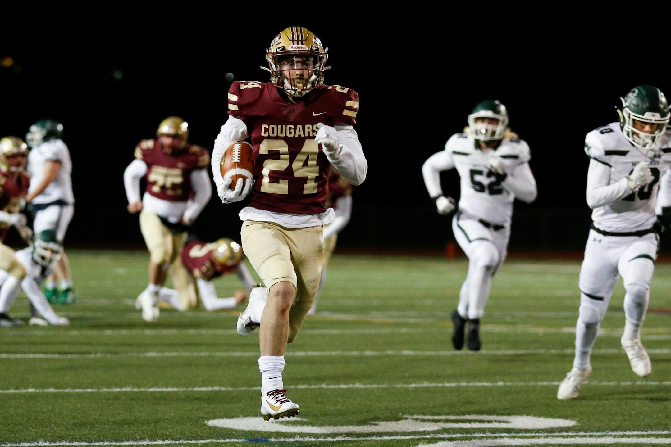 Lakeville South running back Johnny Shabaz (24) leads the No. 2-ranked Cougars in their matchup with No. 1-ranked Wayzata in a Class 6A semifinal Friday at U.S Bank Stadium. Photo by Jeff Lawler, SportsEngine