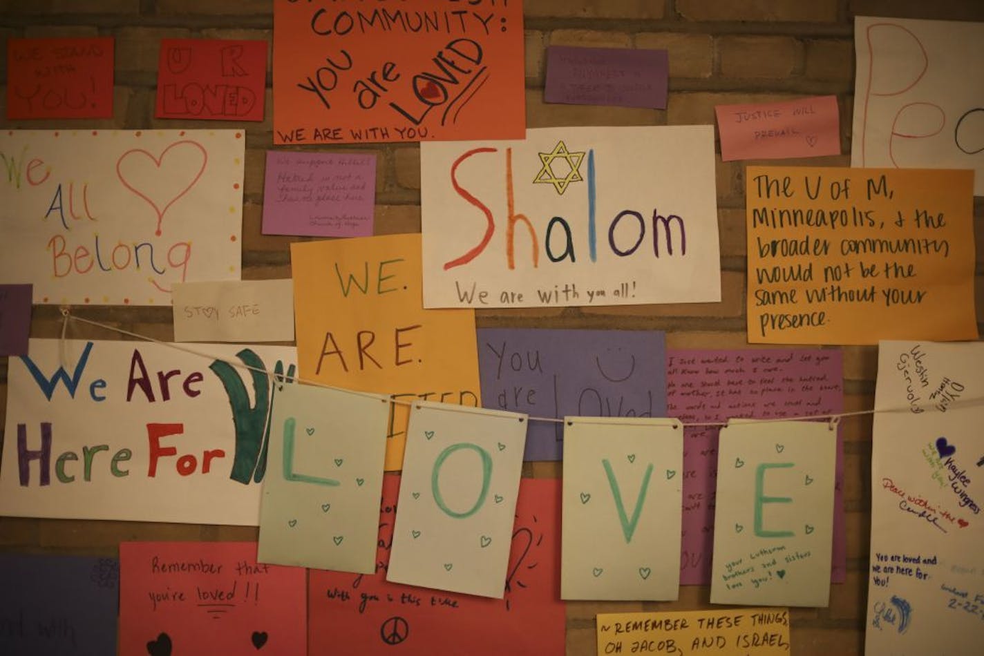 Some of the signs that supporters, including at group from the U's Lutheran Campus Ministry, put up on a wall in the lobby of Minnesota Hillel on Thursday night.