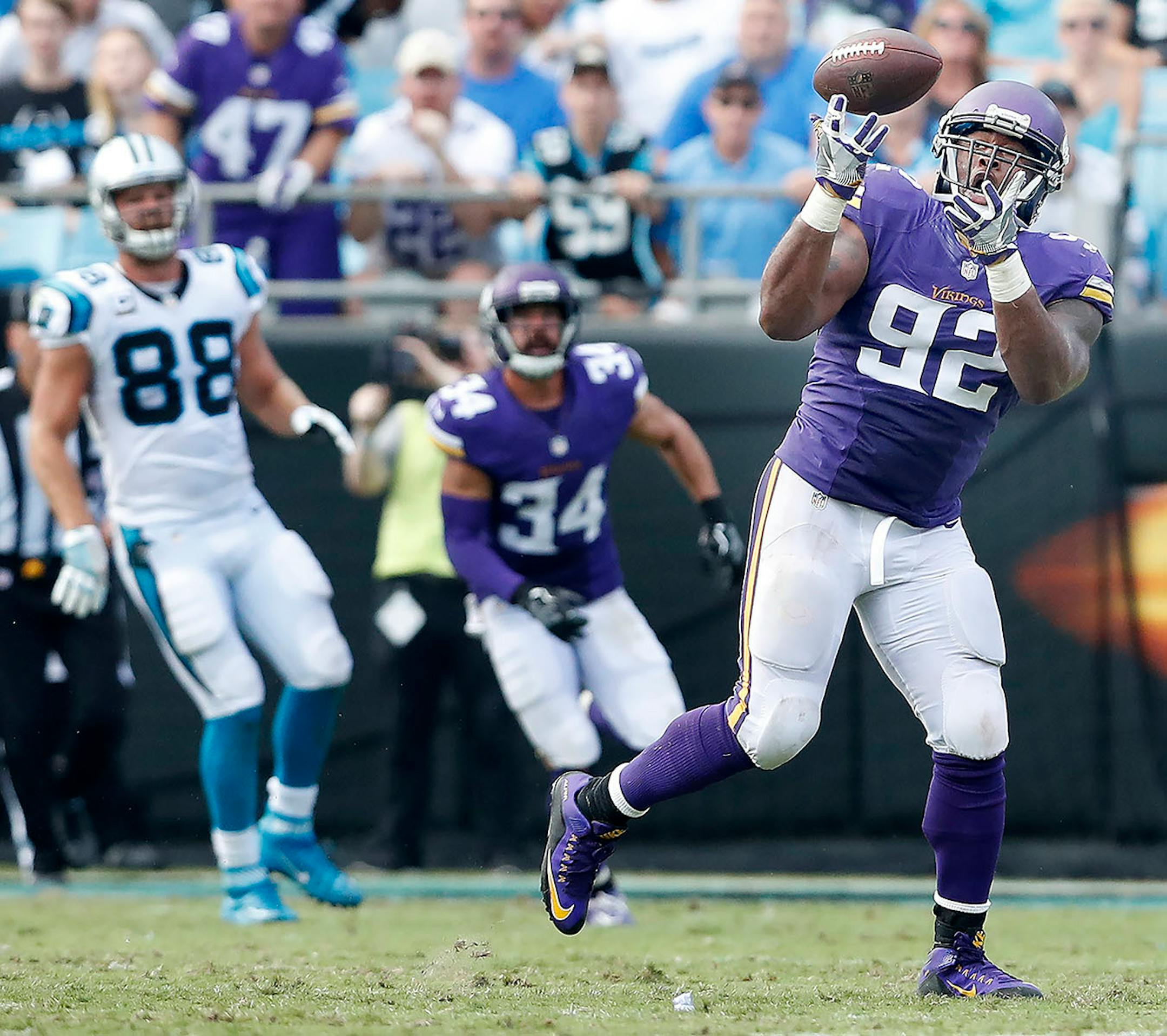 Tom Johnson (92) intercepted a ball thrown by a pressured Cam Newton in the fourth quarter.