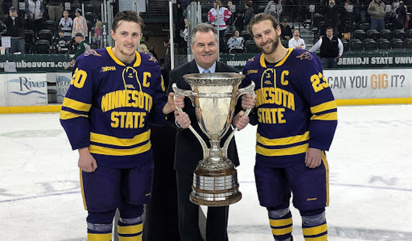 WCHA men's Commissioner Bill Robertson presented the MacNaughton Cup to league champion Minnesota State Mankato.