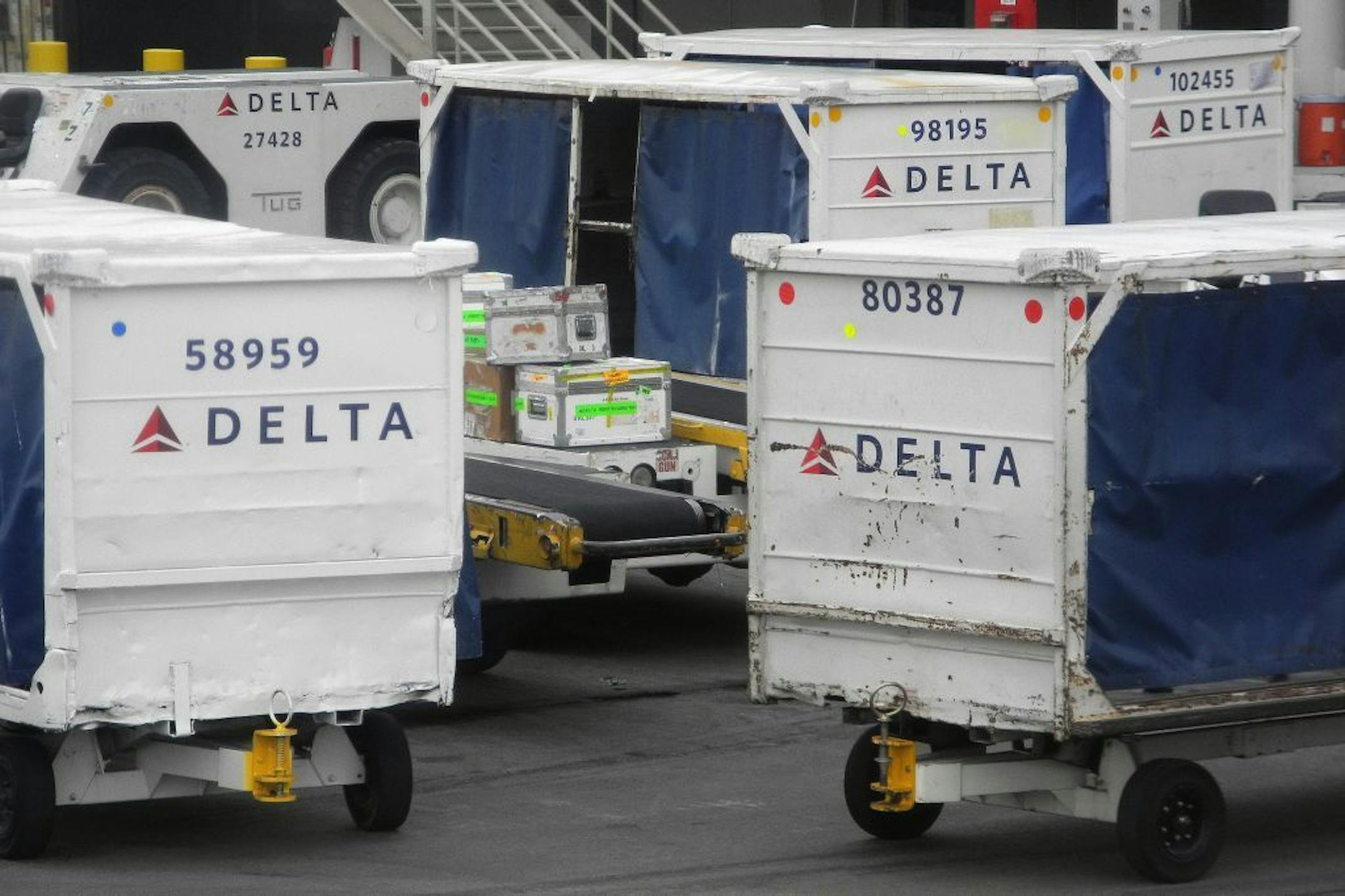 FILE - In tis Aug. 4, 2011 file photo, Delta Airlines luggage carts sit idle at Hartsfield-Jackson Atlanta International Airport, in Atlanta. Higher fares helped Delta Air Lines Inc. produce a bigger third-quarter profit Tuesday, Oct. 25, 2011, even though fuel prices jumped sharply and passenger traffic was flat.