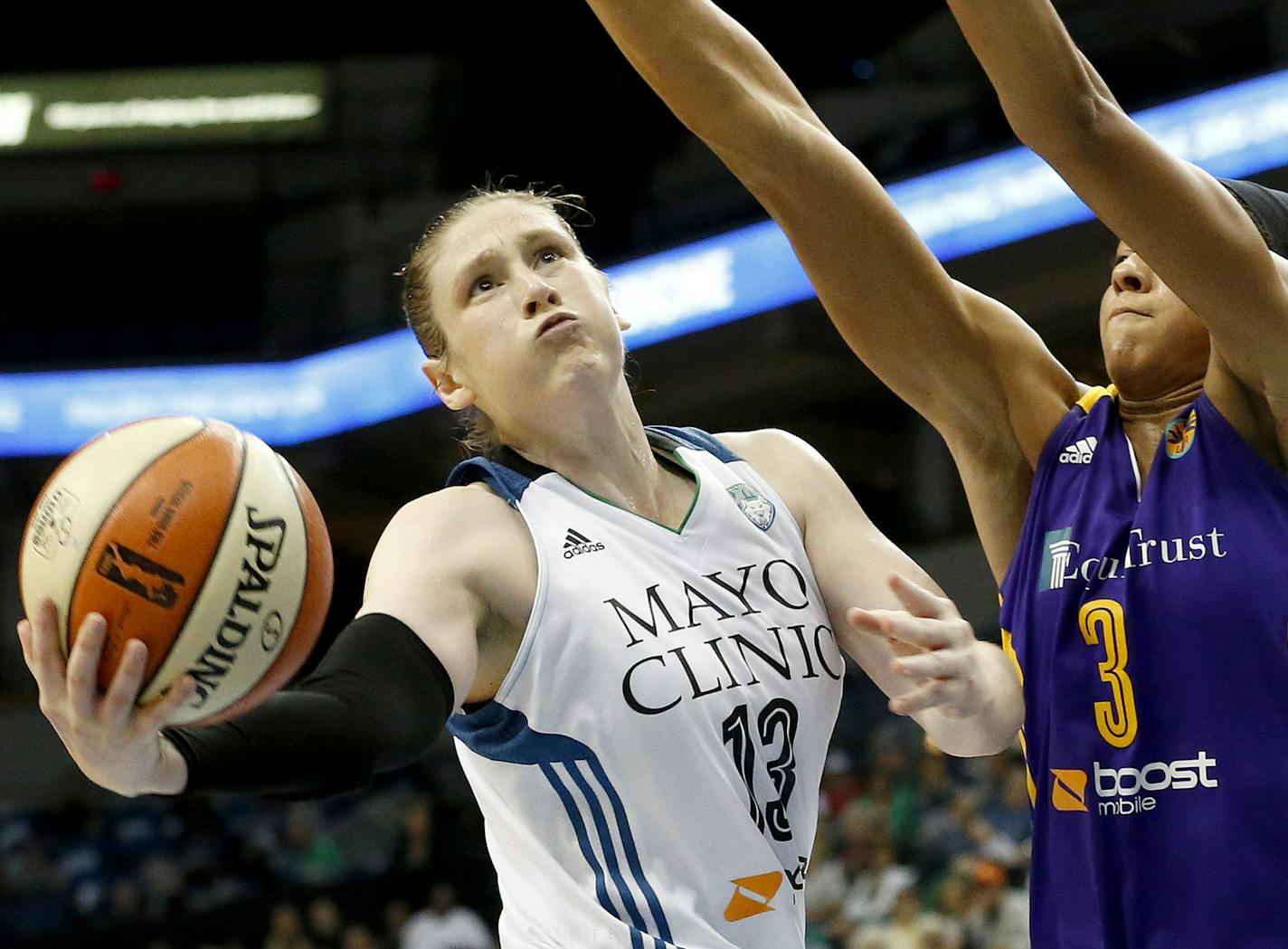 Lynx point guard Lindsay Whalen (13) is fouled by Candace Parker (3) in the third quarter of the WNBA game on Sept. 22, 2015 in Minneapolis. The Minnesota Lynx beat the Los Angeles Sparks 91-80 to take game 3 and the Western Conference Semifinals. (Carlos Gonzalez/Minneapolis Star Tribune/TNS) ORG XMIT: 1174182