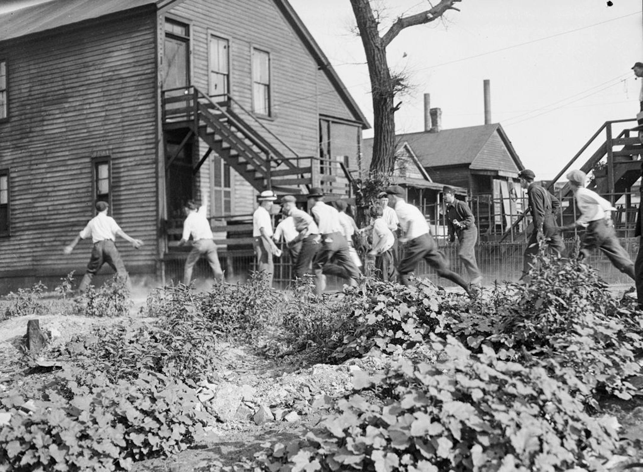 In this 1919 photo provided by the Chicago History Museum, a victim is stoned and bludgeoned under a corner of a house during the race riots in Chicago. Hundreds of African Americans died at the hands of white mobs during "Red Summer," as the summer of 1919 came to be known, but little is known nationally about this summer of violence 100 years later.