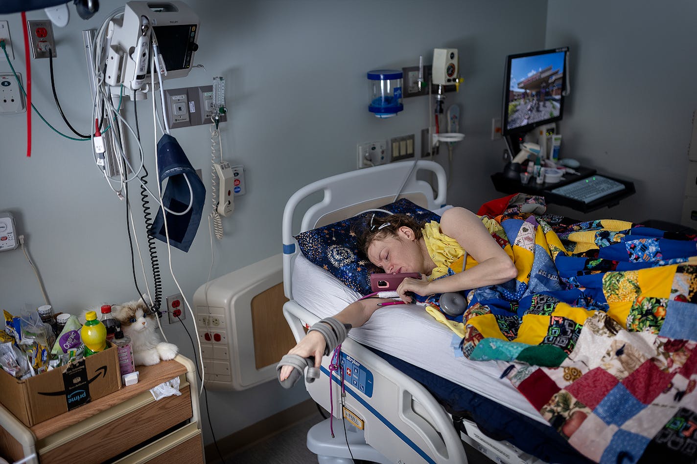 Cindy Hagen talks on the phone in her hospital room at the Mayo Clinic Hospital in Austin, Minn., on Wednesday, Jan. 25, 2023. Hagen has been confined to a hospital room because she can't find caregivers to support her at home. The 49-year-old woman, who has limited mobility because of her disability, won a legal victory that she hopes will let her move home in May.