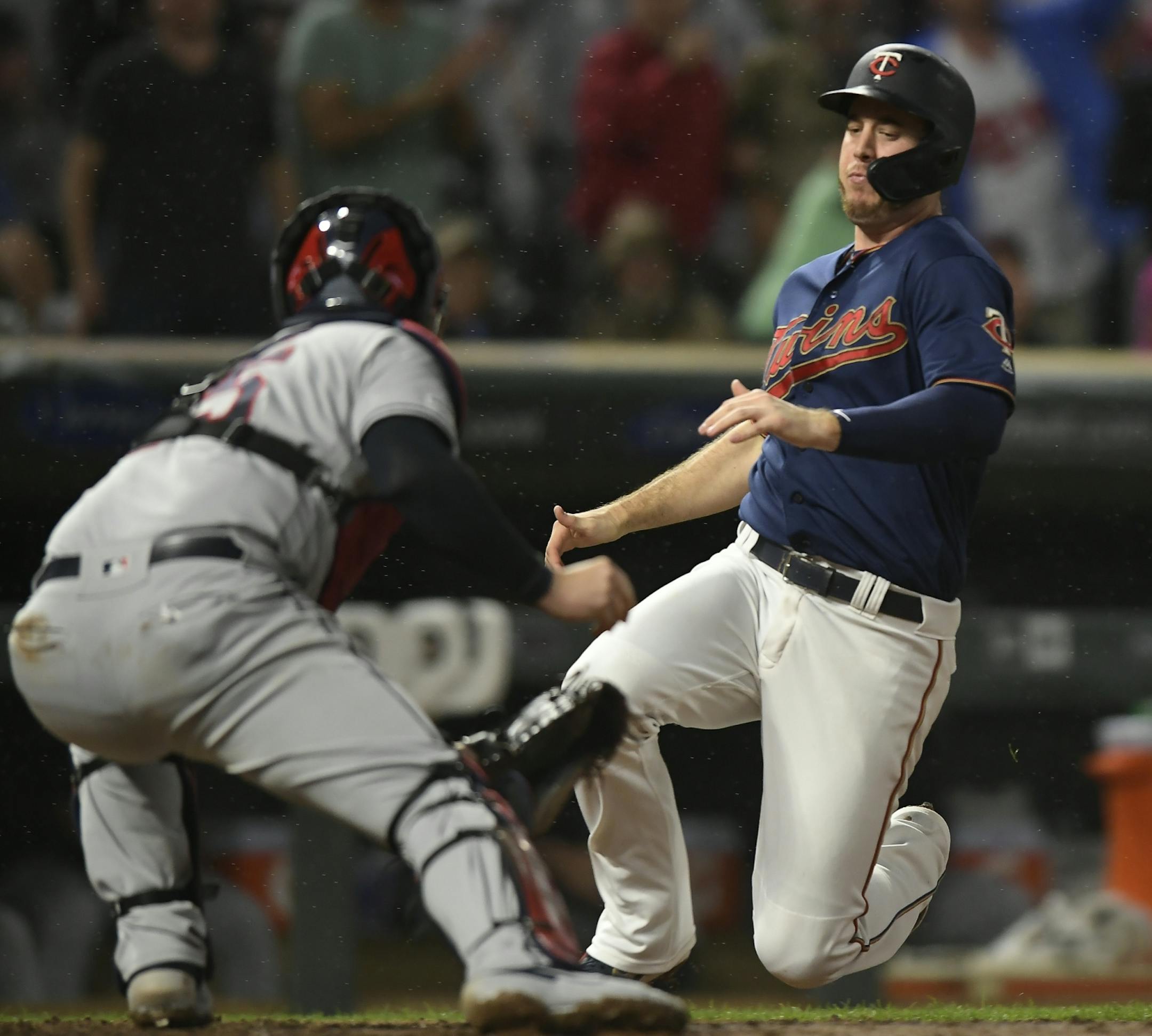 Minnesota Twins first baseman C.J. Cron (24) was tagged out at home by Cleveland Indians catcher Roberto Perez (55) in the bottom of the fourth inning.
