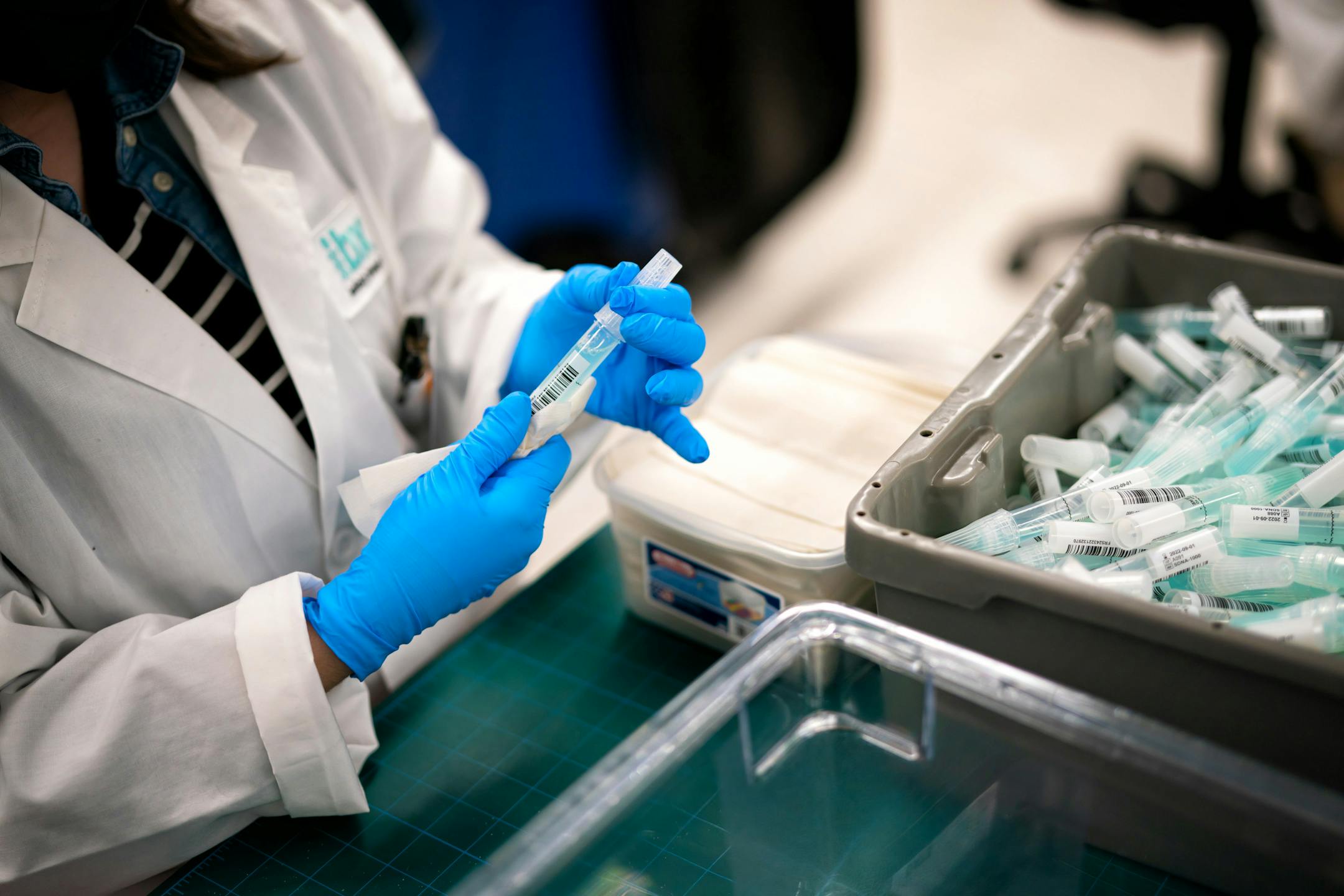 Alison Barnes decontaminated incoming saliva sample tubes as they arrive at IBX processing area.