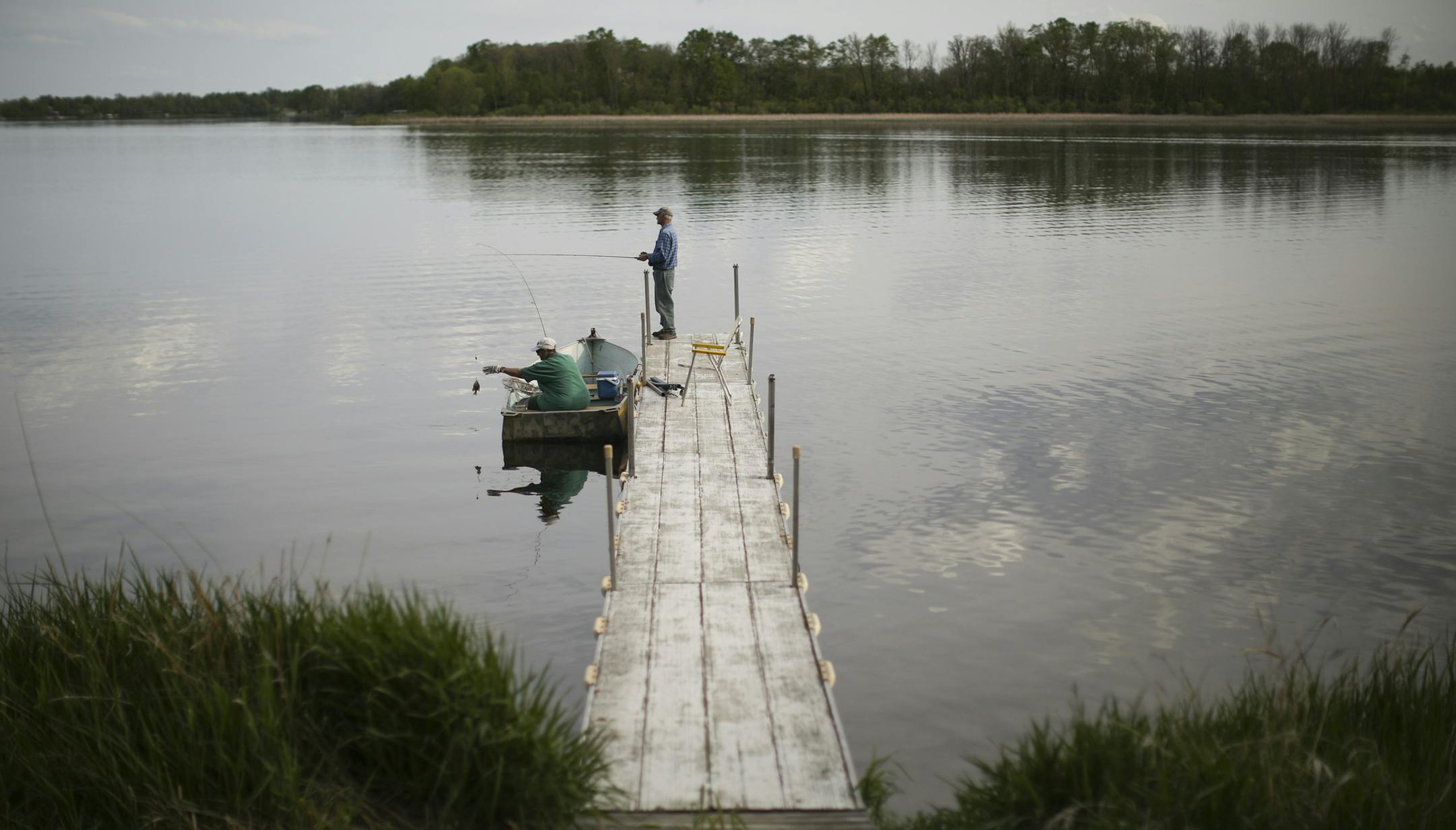 Guests at Lakecrest Resort on Long Lake fished off one of the docks. Amy Wolf and her husband, Kregg, bought the Detroit Lakes resort in January and have been getting ready for summer.