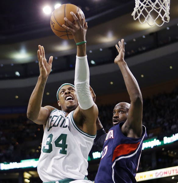 Boston Celtics' Paul Pierce (34) shoots against Atlanta Hawks' Johan Petro (10)during the third quarter of an NBA basketball game in Boston, Friday, M