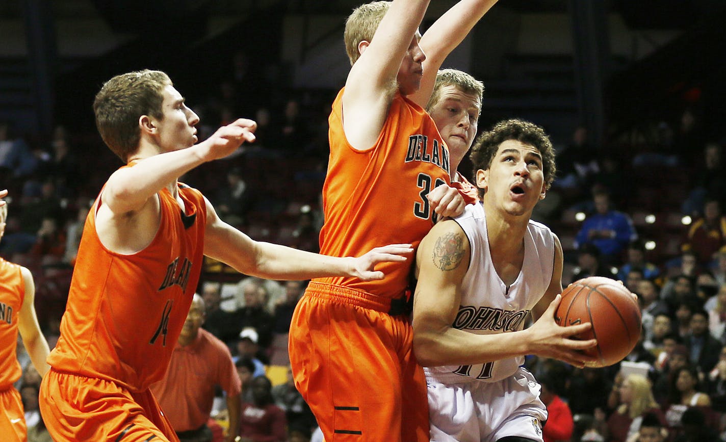 Robert Chattard of Johnson looks to pass around Delano defenders during 3A quarterfinals basketball action between St. Paul Johnson and Delano at Williams Arena Wednesday March, 20, 2013 in Minneapolis, MN. Johnson beat Delano 64-65.] JERRY HOLT &#x201a;&#xc4;&#xa2; jerry.holt@startribune.com