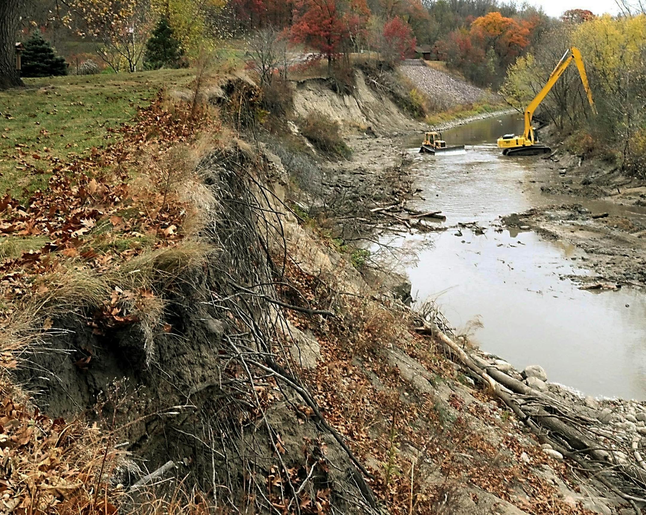 Erosion_Research_MNMAN101.jpg.In this Oct. 25, 2011, photo, workers use an excavator and bulldozer to work in the Le Sueur River to stabilize river banks with large tree trunks near Mankato, Minn. Researchers in southern Minnesota are hoping a photo a day will show where the bluffs are washing away in the Le Sueur River watershed. And that may help guide policy makers on the best ways to slow the damaging sediment loads that are clouding the Mississippi River, filling in Lake Pepin and carrying