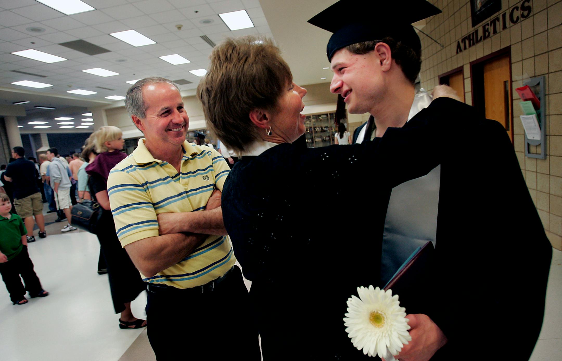 Stefan hugged his mother, Barb, after Friday's graduation ceremony. At left is Stefan's father, Jerry Kavan.