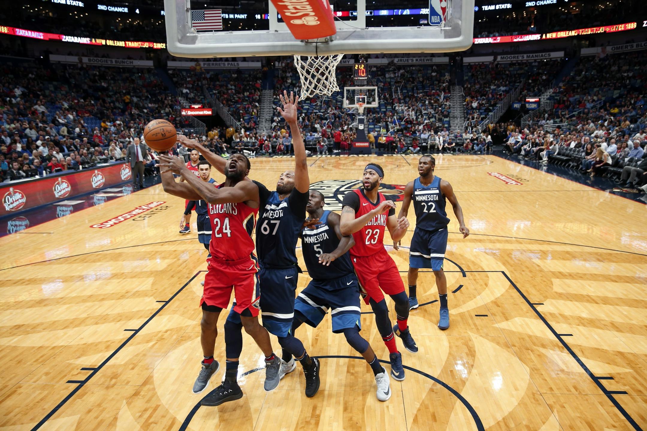 Minnesota Timberwolves forward Taj Gibson (67) swats the ball from New Orleans Pelicans guard Tony Allen (24) as Timberwolves center Gorgui Dieng (5) and Pelicans forward Anthony Davis (23) vie fro position in the first half of an NBA basketball game in New Orleans, Wednesday, Nov. 29, 2017.