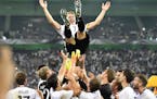 Germany's national team throws their captain Bastian Schweinsteiger into the air after he played his last match for the national team in Moenchengladb