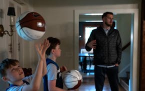 Minnesota Timberwolves basketball fans Everest Moeding, 9, left, and his brother Elliot Moeding, 12, got a visit from Gophers men's basketball forward