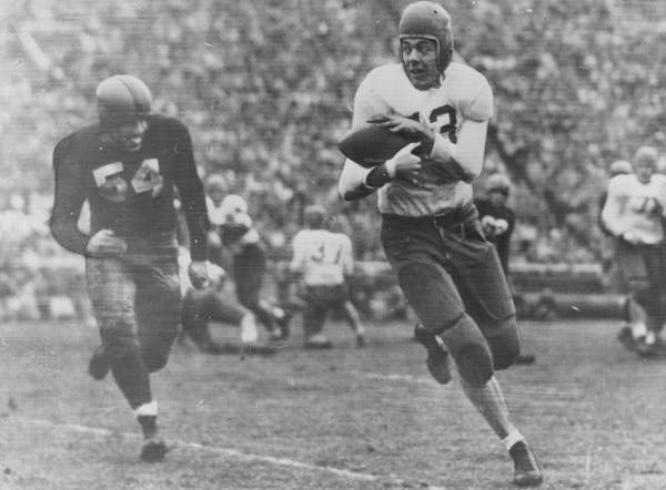 Wisconsin's Joe Kelly chases as Bud Grant grabs a pass for the Gophers in 1948. Grant would go on to play professionally for the Eagles.