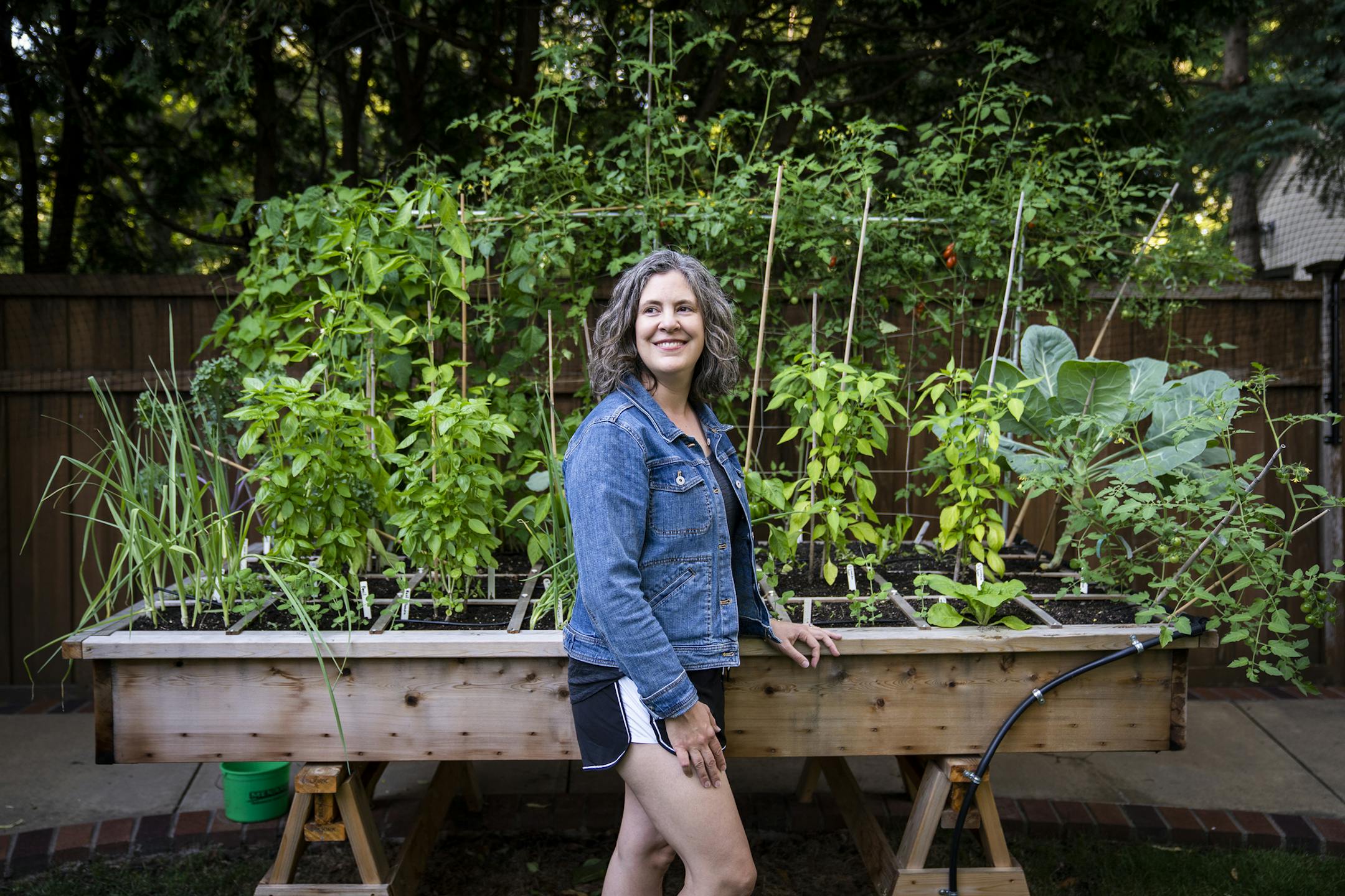 Lindsay Brice appreciates the fresh vegetables growing in her backyard garden in St. Paul. The garden was installed and is tended by A Backyard Farm, a company that helps rookie gardeners and people too busy to keep up with their own garden.