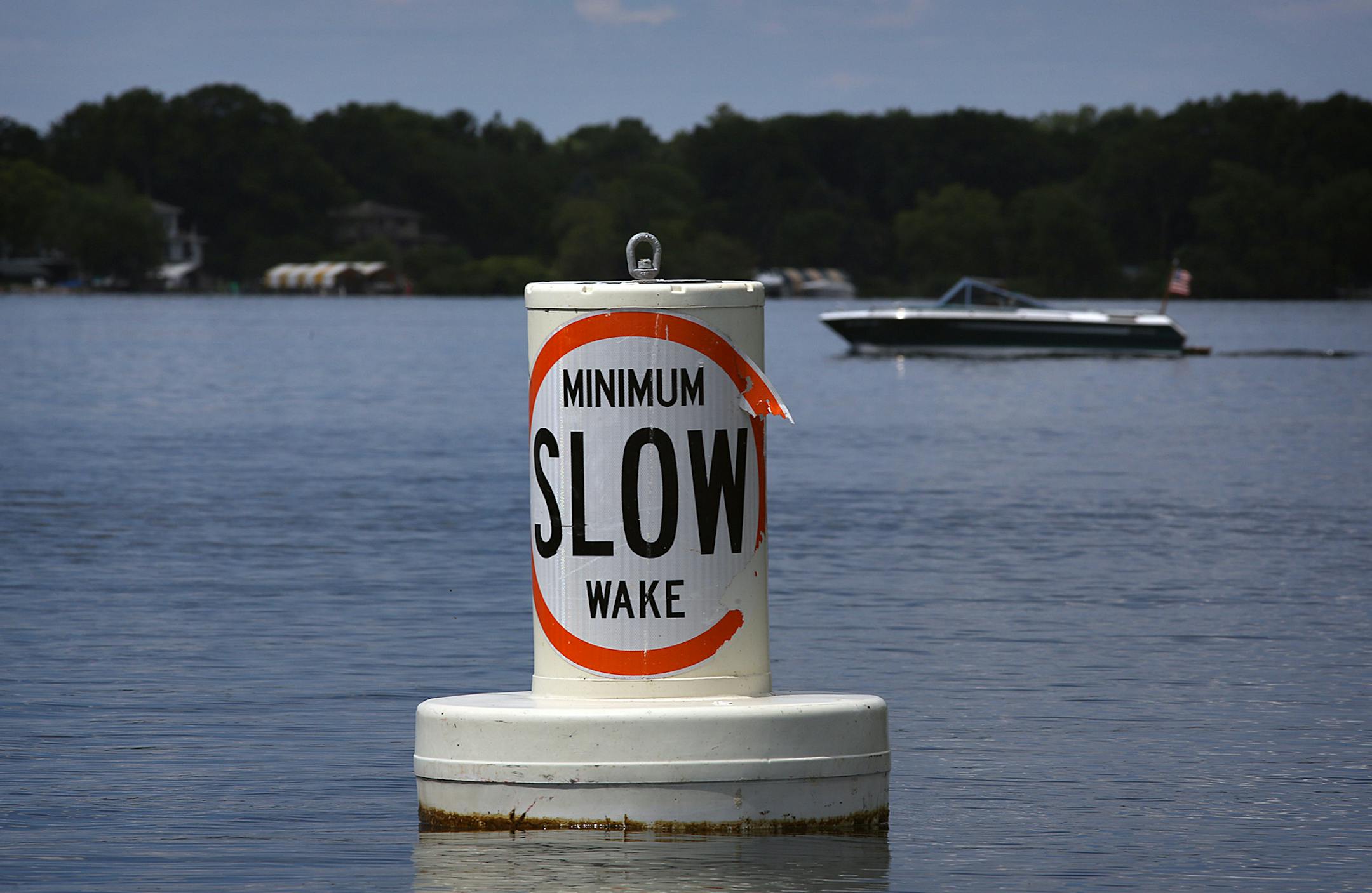 A buoy informs boaters of the rules in force on Lake Minnetonka designed to reduce wakes. ]JIM GEHRZ ‚Ä¢ jgehrz@startribune.com / Excelsior, MN / July 3, 2014 / 11:00 AM / BACKGROUND INFORMATION: The July 4th weekend is usually the busiest weekend of the entire year for Lake Minnetonka and other Minnesota waterways. But not this year. Record flooding has forced unprecedented wake restrictions on lakes like Minnetonka, turning a usually raucous, crowded lake of jet-skiers, boats