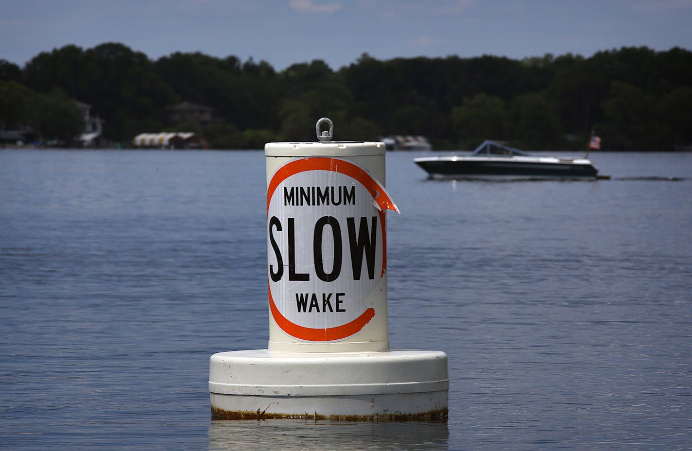 A buoy informs boaters of the rules in force on Lake Minnetonka designed to reduce wakes. ]JIM GEHRZ &#x201a;&#xc4;&#xa2; jgehrz@startribune.com / Excelsior, MN / July 3, 2014 / 11:00 AM / BACKGROUND INFORMATION: The July 4th weekend is usually the busiest weekend of the entire year for Lake Minnetonka and other Minnesota waterways. But not this year. Record flooding has forced unprecedented wake restrictions on lakes like Minnetonka, turning a usually raucous, crowded lake of jet-skiers, boats