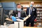 Paul Krogh, director of pharmacy services for North Memorial Health Hospital, unboxed the 975 doses of the Pfizer COVID-19 vaccine that arrived early 