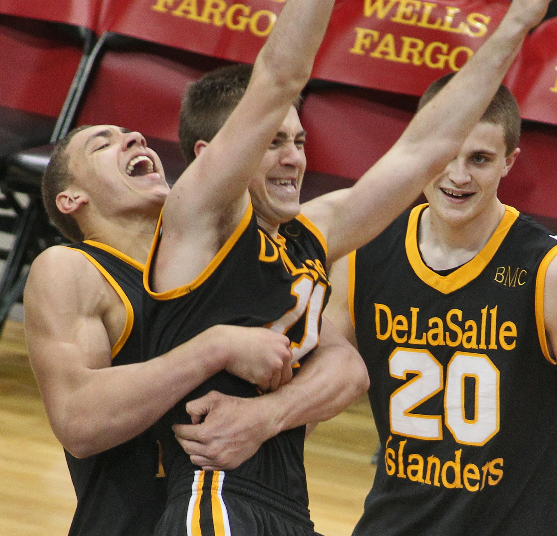 Class 3A Boys Prep Basketball Championship - DeLaSalle vs. Minneapolis Washburn. DeLaSalle won in overtime 57-56. Teammates, including Reid Travis, left, hugged Ross Barker at the end of the game after he scored the winning basket in overtime. (MARLIN LEVISON/STARTRIBUNE(mlevison@startribune.com (cq -program )