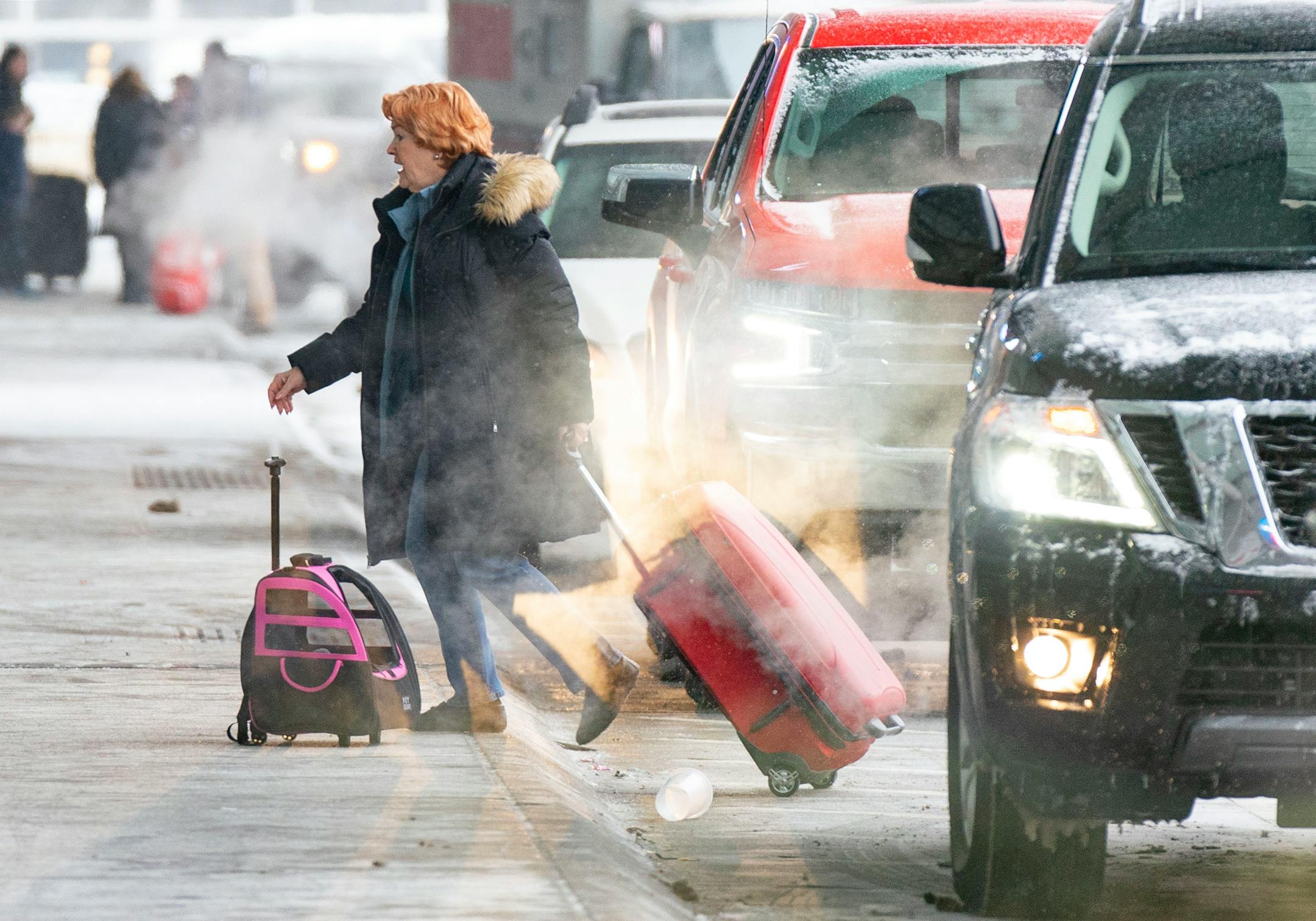 A traveler walks into Terminal 1 at Minneapolis-Saint Paul International Airport.