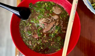 In boat noodle soup, a rich beef broth is perfumed with warm Burmese spices and served over rice noodles packed with fresh herbs.