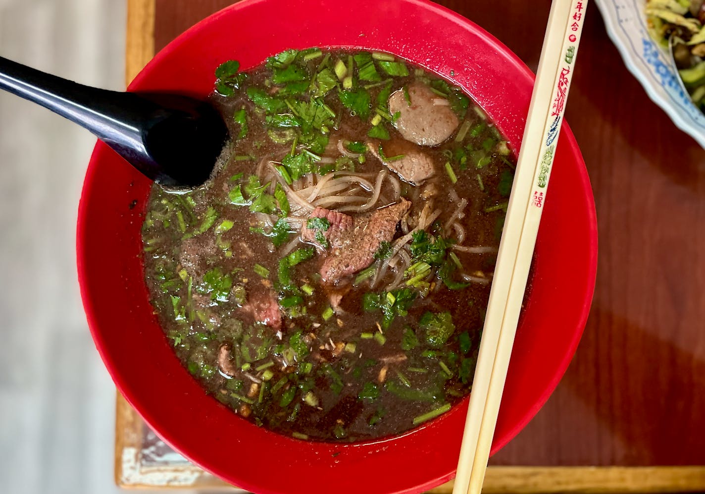 In boat noodle soup, a rich beef broth is perfumed with warm Burmese spices and served over rice noodles packed with fresh herbs.