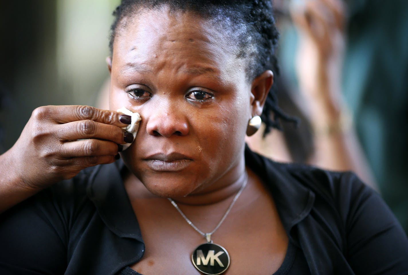 Barway Collins mother, Louis Karluah had a tears wiped from her eyes after attending the court hearing at which Barway&#xed;s father, Pierre Collins, pleaded guilty to killing the 10-year-old boy Monday August 3, 2015 in Minneapolis, MN. ] Jerry Holt/ Jerry.Holt@Startribune.com